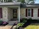 Charming front entrance featuring a well-manicured garden and a brick facade at 104 Walnut Ct, Noblesville, IN 46062