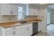 Bright kitchen features white cabinets, stainless steel sink with a wood countertop and stainless steel dishwasher at 104 Walnut Ct, Noblesville, IN 46062