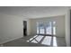 Bright living room with a view to the backyard, a glimpse of the kitchen, and light-colored floors at 104 Walnut Ct, Noblesville, IN 46062