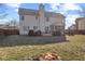 View of the backyard with a fire pit, deck, chairs, and a charming playhouse at 1062 Scarlet Quarry Cir, Avon, IN 46123