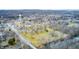 Picturesque aerial view of a quaint town featuring cozy homes, lush greenery, and a peaceful river at 114 E Mill St, Brooklyn, IN 46111