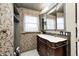 Bathroom featuring a decorative vanity, ornate wallpaper and a window at 114 E Mill St, Brooklyn, IN 46111