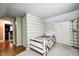 Neutral colored bedroom featuring wood floors and a white bed frame at 114 E Mill St, Brooklyn, IN 46111