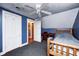 Bedroom featuring wood bed frame, desk, a ceiling fan and two closets at 114 E Mill St, Brooklyn, IN 46111