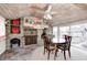 Eat-in dining area featuring a beautiful stone fireplace, vaulted wood ceilings, and ample natural light at 114 E Mill St, Brooklyn, IN 46111