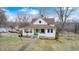 Traditional two-story home with a covered front porch, mature trees, and spacious yard at 114 E Mill St, Brooklyn, IN 46111