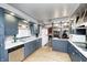Eat-in kitchen with stainless steel appliances, wood floors, stone fireplace and blue cabinets at 114 E Mill St, Brooklyn, IN 46111