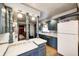 Eat-in kitchen with custom blue cabinets, mosaic backsplash, and wood floors at 114 E Mill St, Brooklyn, IN 46111