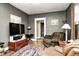 Comfortable living room with a large TV, a plush chair, and hardwood floors at 114 E Mill St, Brooklyn, IN 46111