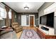 Comfortable living room with a large TV, a plush chair, and hardwood floors at 114 E Mill St, Brooklyn, IN 46111