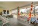 Inviting porch features swing, vintage furniture, and seasonal decor offering a cozy outdoor living space at 114 E Mill St, Brooklyn, IN 46111