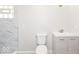 Modern bathroom featuring marble-tiled shower, toilet, and light gray vanity with white sink at 117 W Mckenzie Rd, Greenfield, IN 46140