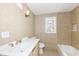 Well-lit bathroom with tiled walls, modern vanity, and a combination tub and shower at 117 W Mckenzie Rd, Greenfield, IN 46140