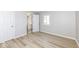 Bright bedroom with light gray walls, hardwood flooring, a closet, and a window offering natural light at 117 W Mckenzie Rd, Greenfield, IN 46140