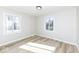 Bright bedroom features hardwood floors, two large windows, and light walls at 117 W Mckenzie Rd, Greenfield, IN 46140
