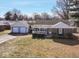 Charming single-story home with brick accents, a covered porch, and an attached two-car garage at 117 W Mckenzie Rd, Greenfield, IN 46140