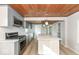 Modern kitchen featuring gray cabinets, stainless steel appliances, and a center island with quartz countertop at 117 W Mckenzie Rd, Greenfield, IN 46140