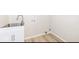 Bright laundry room area features a stainless-steel sink, white cabinets, and convenient utility connections at 117 W Mckenzie Rd, Greenfield, IN 46140
