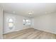Bright living room featuring light wood floors, fresh paint, and ample natural light at 117 W Mckenzie Rd, Greenfield, IN 46140