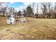 Large backyard featuring a playhouse and swing set, perfect for outdoor activities at 122 S Green St, Brownsburg, IN 46112