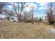 Large backyard with mature trees and a home with blue shutters at 122 S Green St, Brownsburg, IN 46112