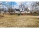 Expansive backyard with a trampoline, surrounded by mature trees and neighboring homes at 122 S Green St, Brownsburg, IN 46112