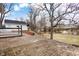 Large brick patio in a spacious backyard with mature trees and a playhouse at 122 S Green St, Brownsburg, IN 46112