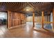 Unfinished basement with wood paneling, tiled floors, and washer and dryer at 122 S Green St, Brownsburg, IN 46112