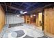 Spacious unfinished basement with exposed ceiling and wood paneled accent wall at 122 S Green St, Brownsburg, IN 46112