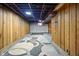 Basement area featuring paneled walls and exposed ceiling with area rug at 122 S Green St, Brownsburg, IN 46112