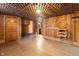 Finished basement area with wood paneling and unique lattice ceiling detail at 122 S Green St, Brownsburg, IN 46112