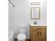 Well-lit bathroom features a wood vanity, white countertops, and subway tile shower at 122 S Green St, Brownsburg, IN 46112