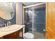 Stylish bathroom featuring blue tiled walls and shower with glass door at 122 S Green St, Brownsburg, IN 46112