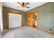 Inviting bedroom features neutral carpet, wood trim, ceiling fan, and a convenient closet space at 122 S Green St, Brownsburg, IN 46112