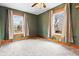 This cozy bedroom features carpet, dual windows, neutral wall color and views to the neighborhood at 122 S Green St, Brownsburg, IN 46112