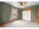 Comfortable bedroom features neutral carpet, wood trim, closet space and a view of the neighborhood at 122 S Green St, Brownsburg, IN 46112