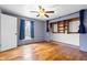 Bedroom featuring hardwood floors, a large window, and built in shelving at 122 S Green St, Brownsburg, IN 46112