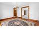 Elegant dining room boasts beautiful wood floors, a classic chandelier, and an adjacent room view at 122 S Green St, Brownsburg, IN 46112