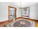 Cozy dining room showcasing hardwood floors, a chandelier, and seamless flow to the living area at 122 S Green St, Brownsburg, IN 46112