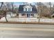 Inviting two-story home featuring a charming front porch, bright blue door, and a lovely white picket fence at 122 S Green St, Brownsburg, IN 46112