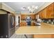 Open-concept kitchen featuring wood cabinetry and stainless steel appliances at 122 S Green St, Brownsburg, IN 46112