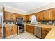 Well-lit kitchen displaying wood cabinets, stainless steel appliances, and ample counter space at 122 S Green St, Brownsburg, IN 46112