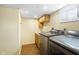 Laundry area featuring modern washer and dryer with sink and storage at 122 S Green St, Brownsburg, IN 46112