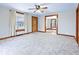 Inviting living room with neutral carpet, wood trim, and a seamless flow to the dining area at 122 S Green St, Brownsburg, IN 46112