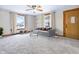 Virtually staged living room with large windows and neutral-toned furnishings at 122 S Green St, Brownsburg, IN 46112