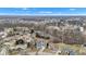 A picturesque aerial view captures the home's setting within a quiet suburban neighborhood with mature trees at 12404 Doe Ln, Indianapolis, IN 46236