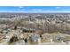 This aerial view showcases the home's location within a quiet suburban neighborhood with mature trees at 12404 Doe Ln, Indianapolis, IN 46236