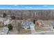 An aerial view showcases this lovely home's location within a serene, wooded neighborhood on an overcast day at 12404 Doe Ln, Indianapolis, IN 46236