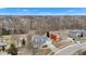 An aerial view showcases this lovely home's location within a serene, wooded neighborhood on an overcast day at 12404 Doe Ln, Indianapolis, IN 46236