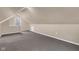 Finished attic area with neutral carpet and natural light, offering potential for storage or flexible space at 12404 Doe Ln, Indianapolis, IN 46236